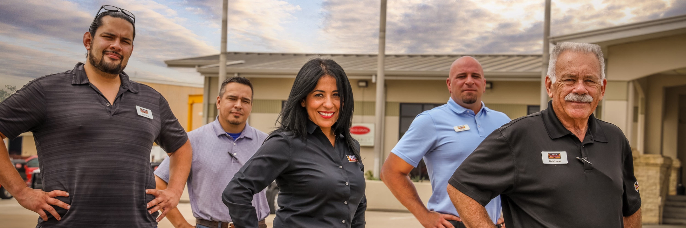 Rush employees standing in front of dealership