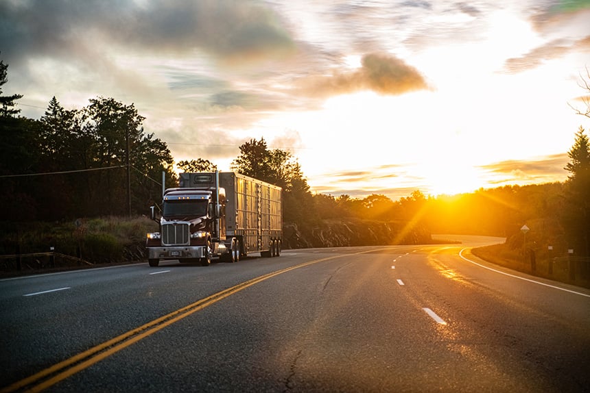 Semi truck driving down empty road